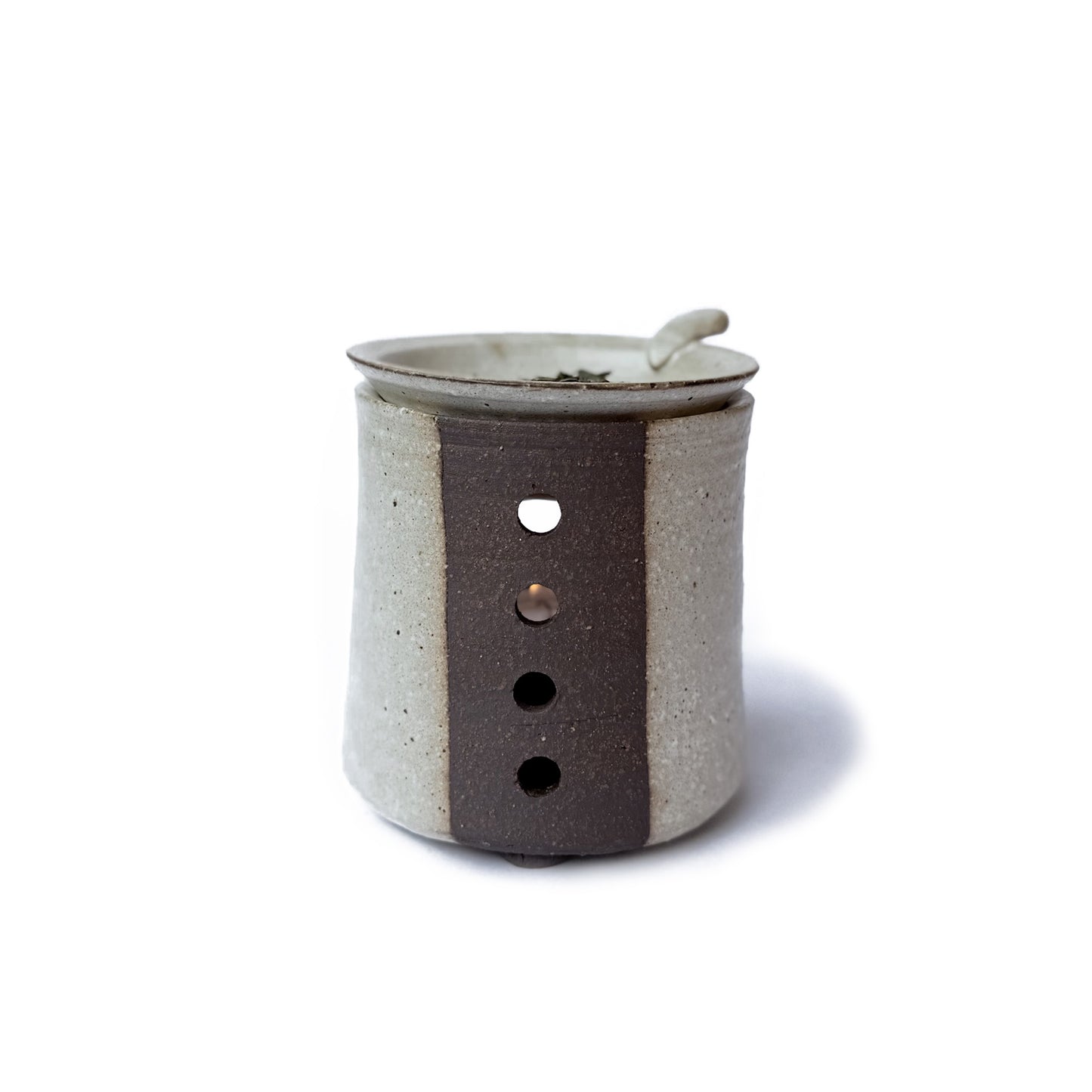 The back of a Charkoro tea diffuser with a small dish on top