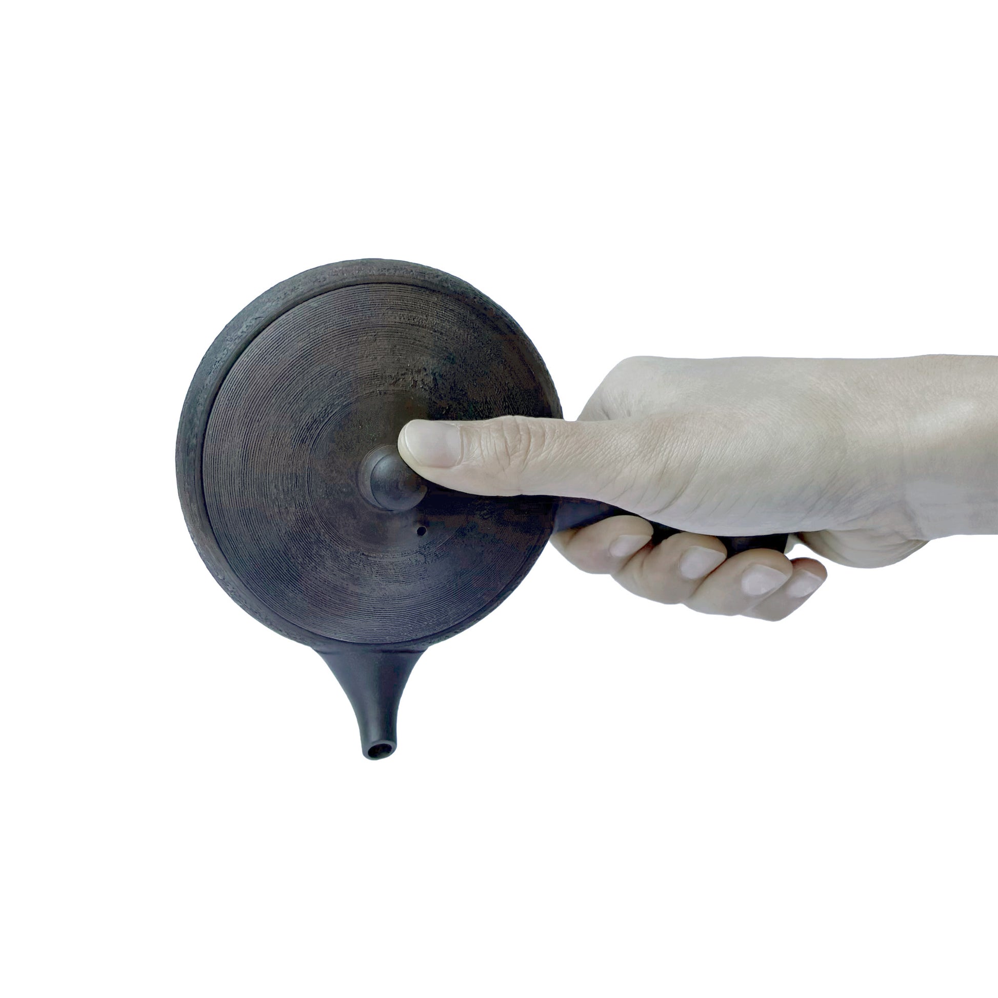 Hand holding GYOKKO teapot against a white background