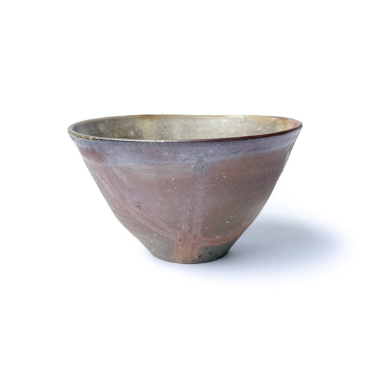 handmade HIDASUKI ceramic matcha bowl with a reddish-brown color and natural ash markings, wheel-thrown and unglazed.