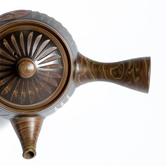 Decorative Tokoname teapot with intricate design on a white background