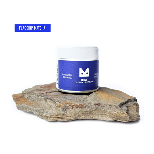 Kiri Organic Uji Matcha container on a rock with a white background