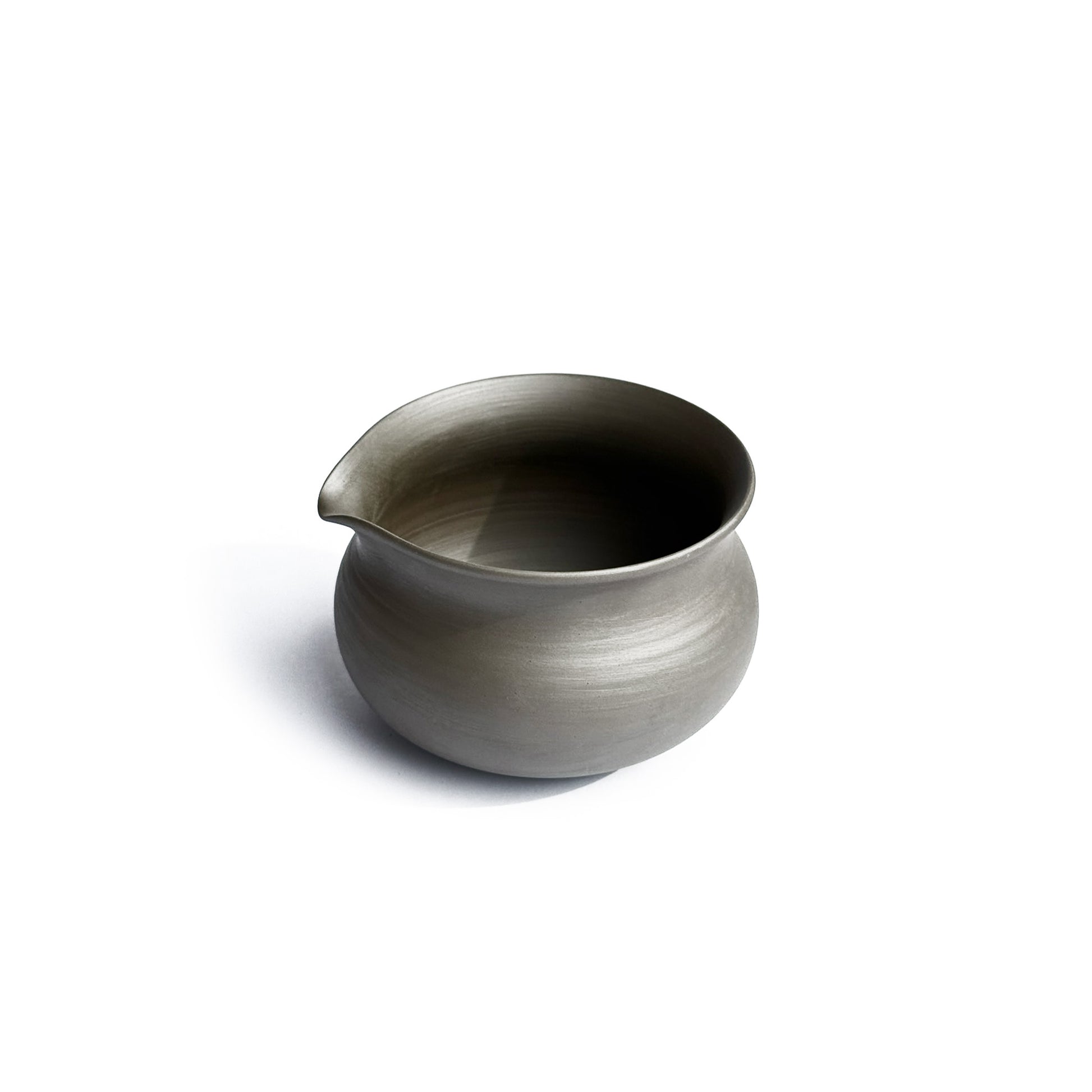 Side view of KITOBI water cooling vessel showing graceful pour spout and ergonomic handle for tea preparation