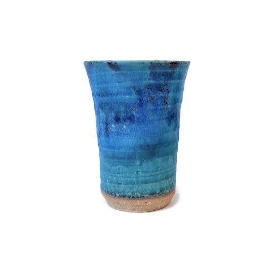 Blue ceramic tall cup on a white background