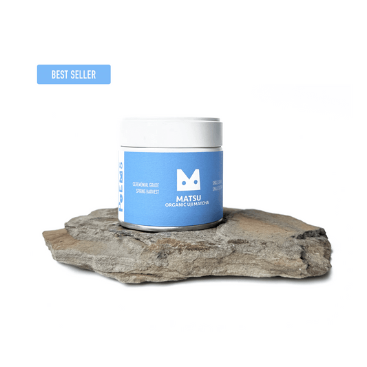 Matsu organic matcha in a white can on a piece of rock with 'Best Seller' label.