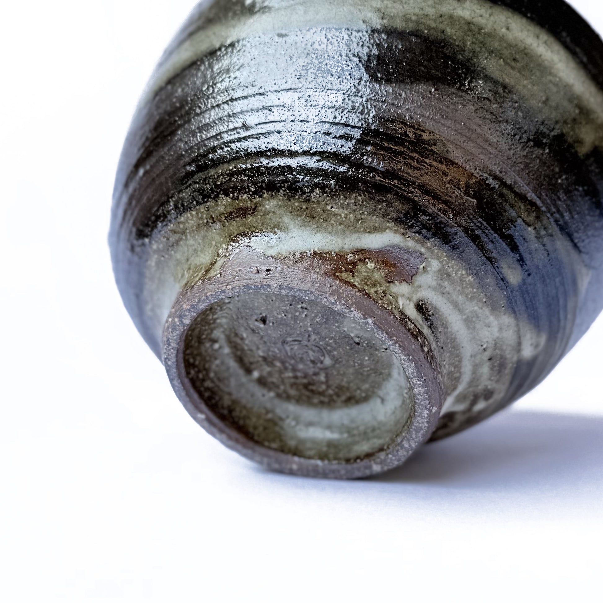 Close-up of the bottom of Orora Maycha Bowl with a textured surface on a white background