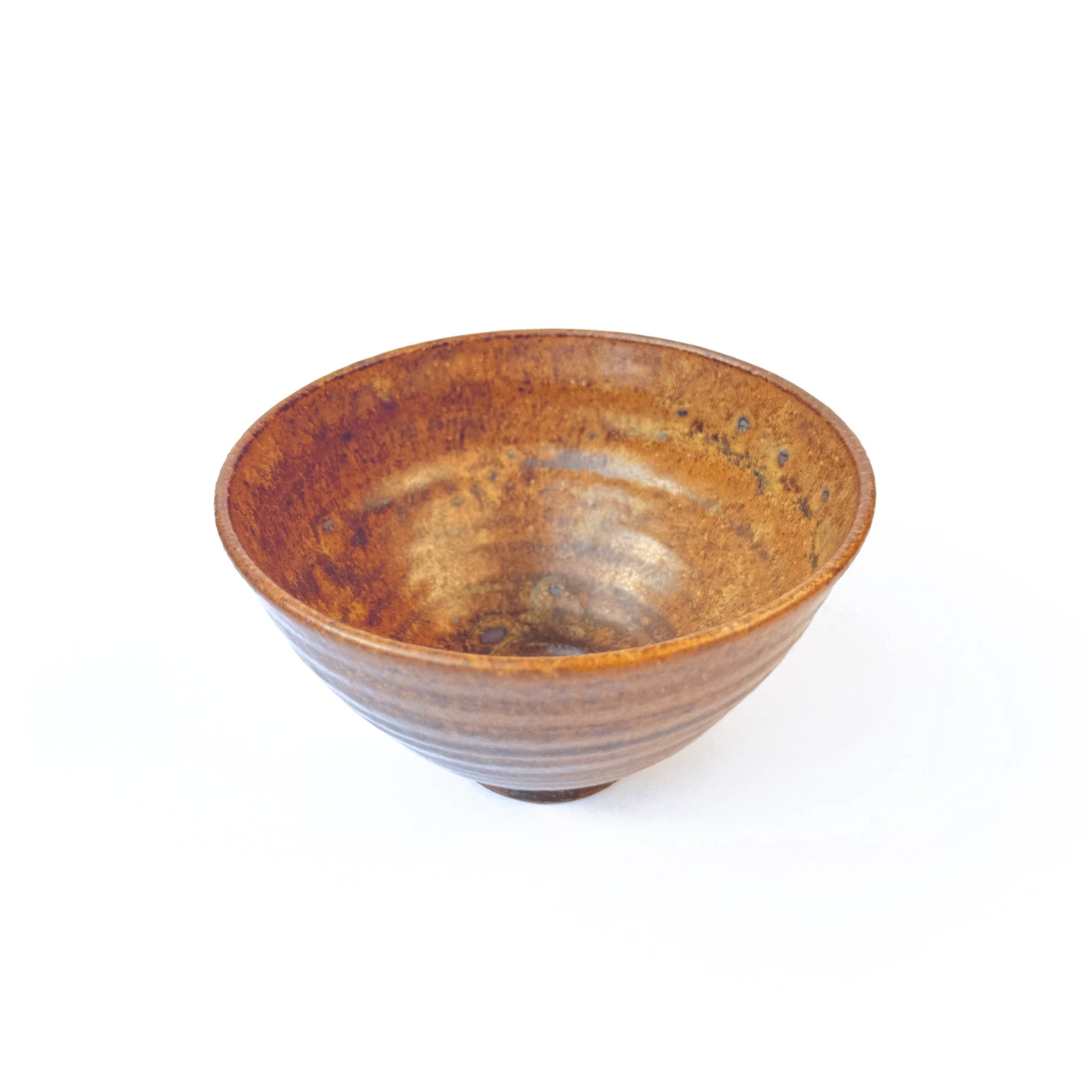 Side view of RAKU ceramic matcha bowl with texture on a white black ground