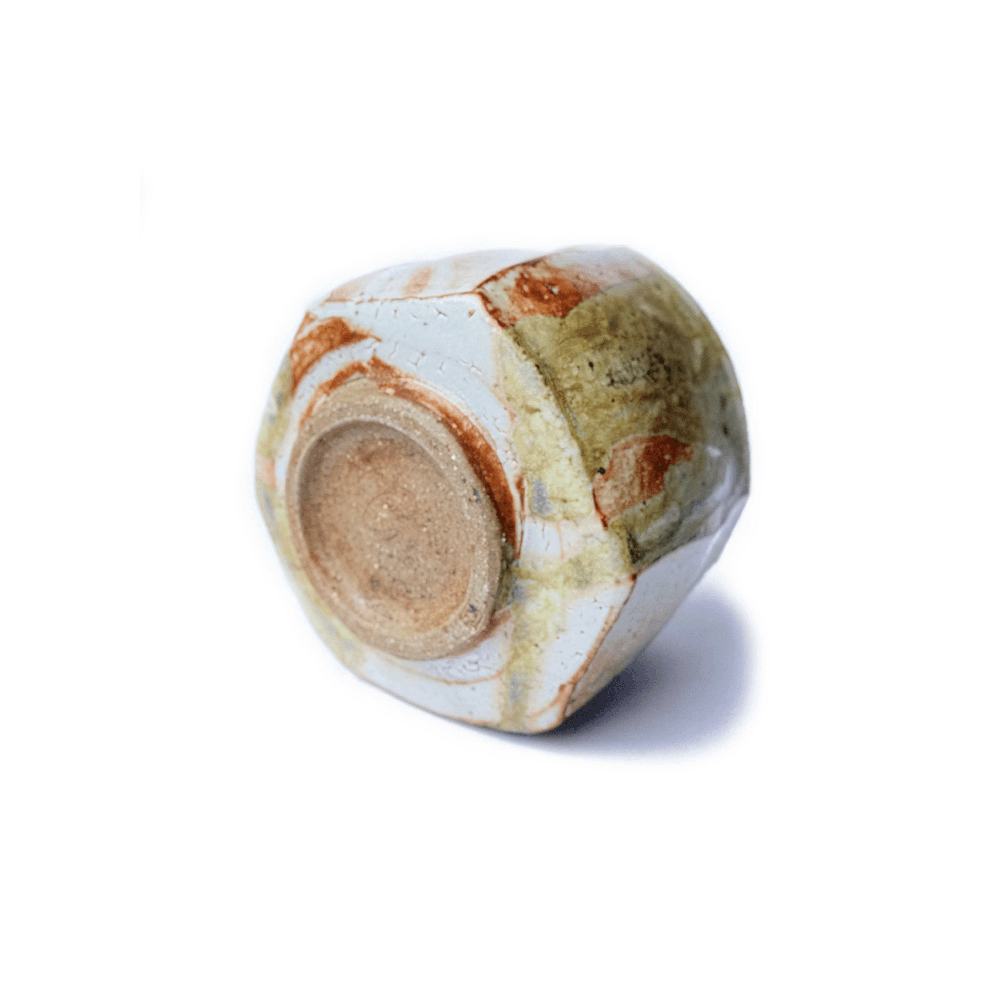 Bottom of SHINO matcha bowl on a white background