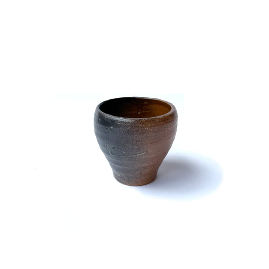 A handcrafted HAI ceramic Yunomi teacup with a rustic finish, isolated on a white background.