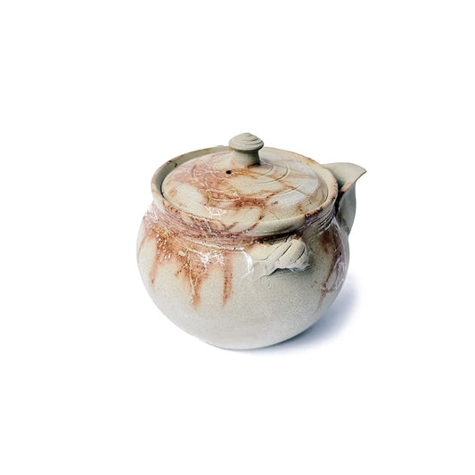 Back of a Ceramic teapot with organic fire mark on a white background