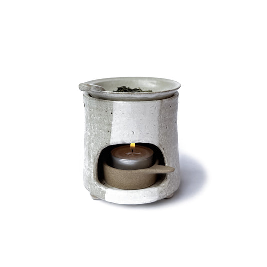 Charkoro tea diffuser with a small candle inside on a white background