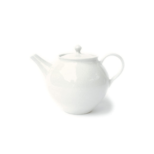 A white ceramic teapot with a textured surface finish, featuring a rounded body, a curved spout, and a loop handle, set against a plain white background.