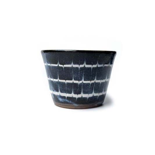 Blue patterned teacup on a white background