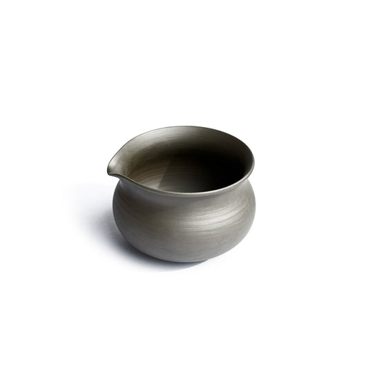 Side view of KITOBI water cooling vessel showing graceful pour spout and ergonomic handle for tea preparation