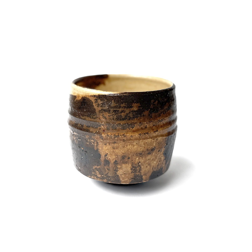 Ceramic matcha bowl with a textured surface on a white background