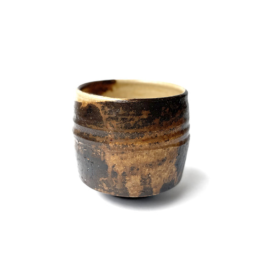 Ceramic matcha bowl with a textured surface on a white background