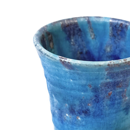 Close-up of MIZUIRO ceramic cup with speckled pattern on a white background