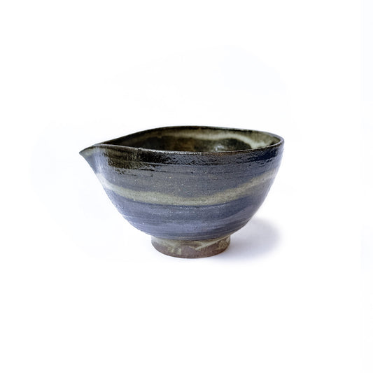 Handcrafted Orora matcha bowl in earthy green glaze with speckled texture