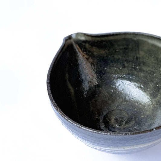 Traditional ceramic matcha bowl with smooth white interior and rustic exterior finish