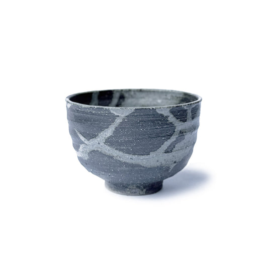 Rikyunezumi ceramic matcha bowl with abstract patterns on a white background