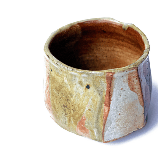 SHINO matcha bowl with multicolored glaze on a white background