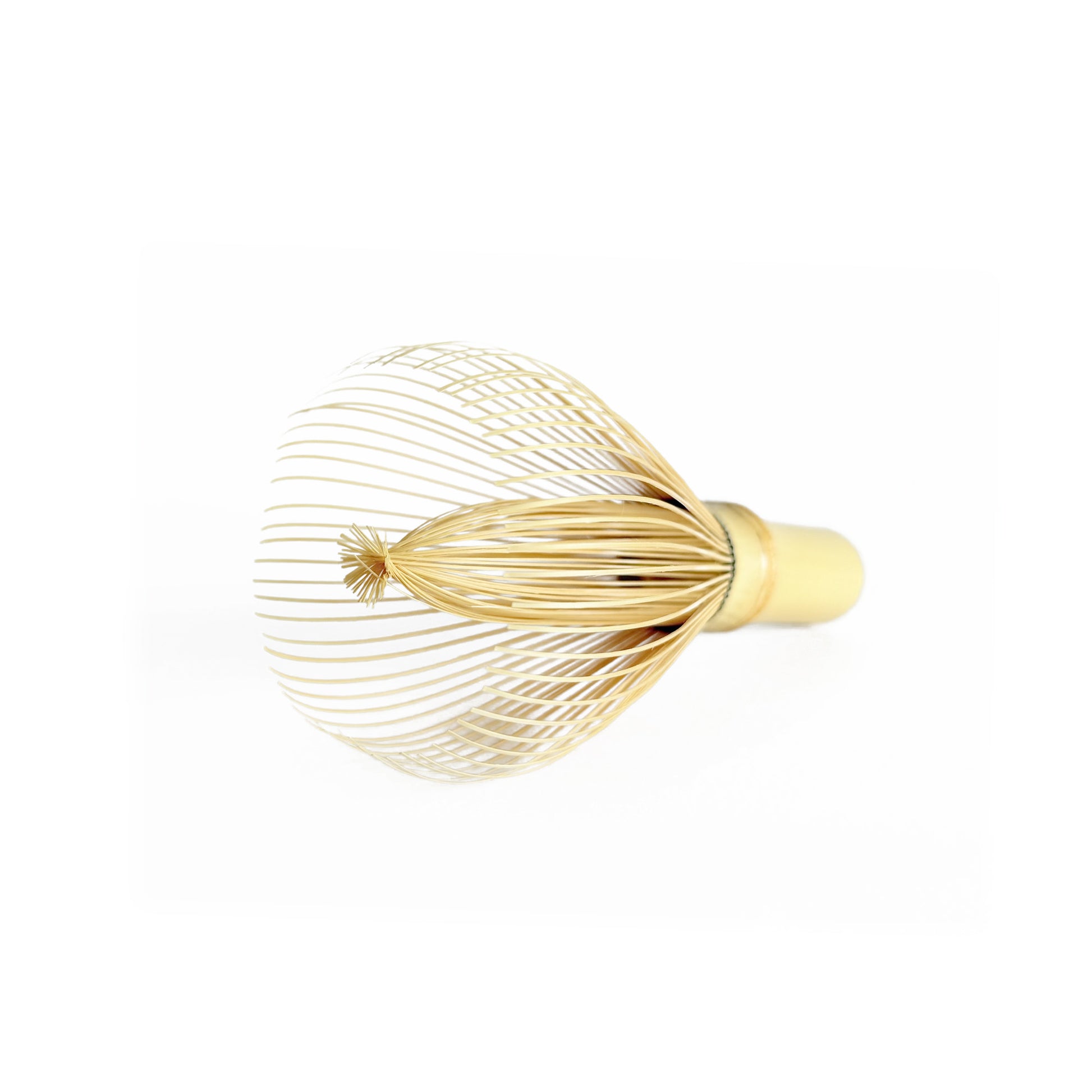 Handcrafted bamboo matcha whisk shown from above, displaying intricate tine pattern for optimal whisking