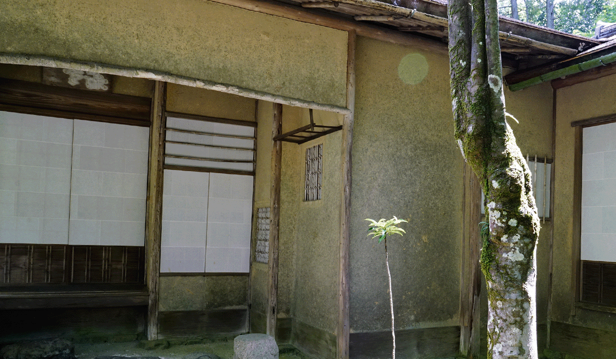 Traditional Japanese tea house with wooden walls in foreground